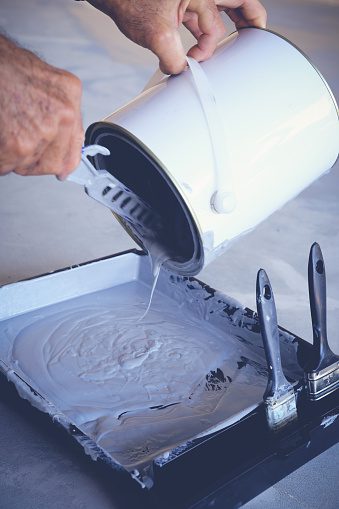 Painting Contractor Pouring Paint